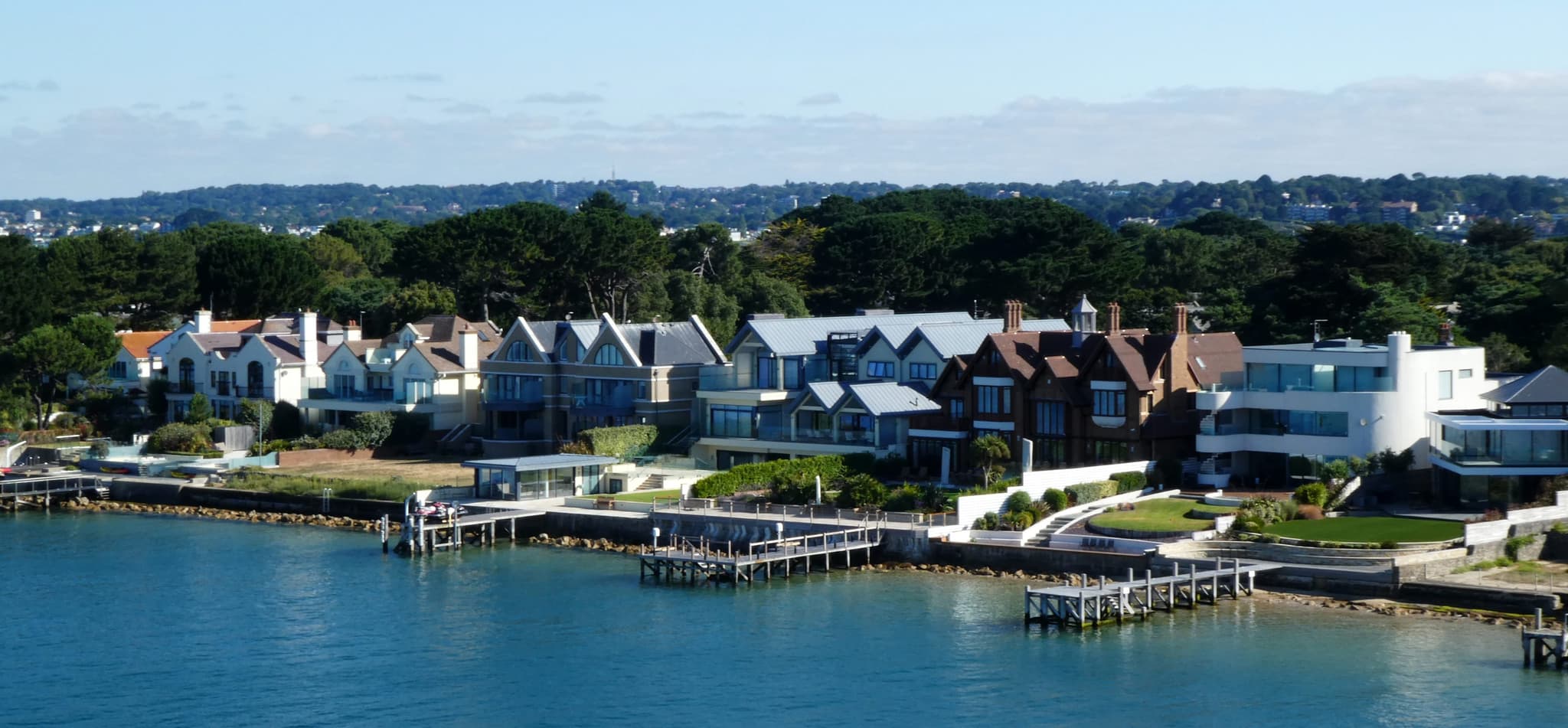 Waterfront homes along the Sandbanks peninsula, Poole, seen from the harbour