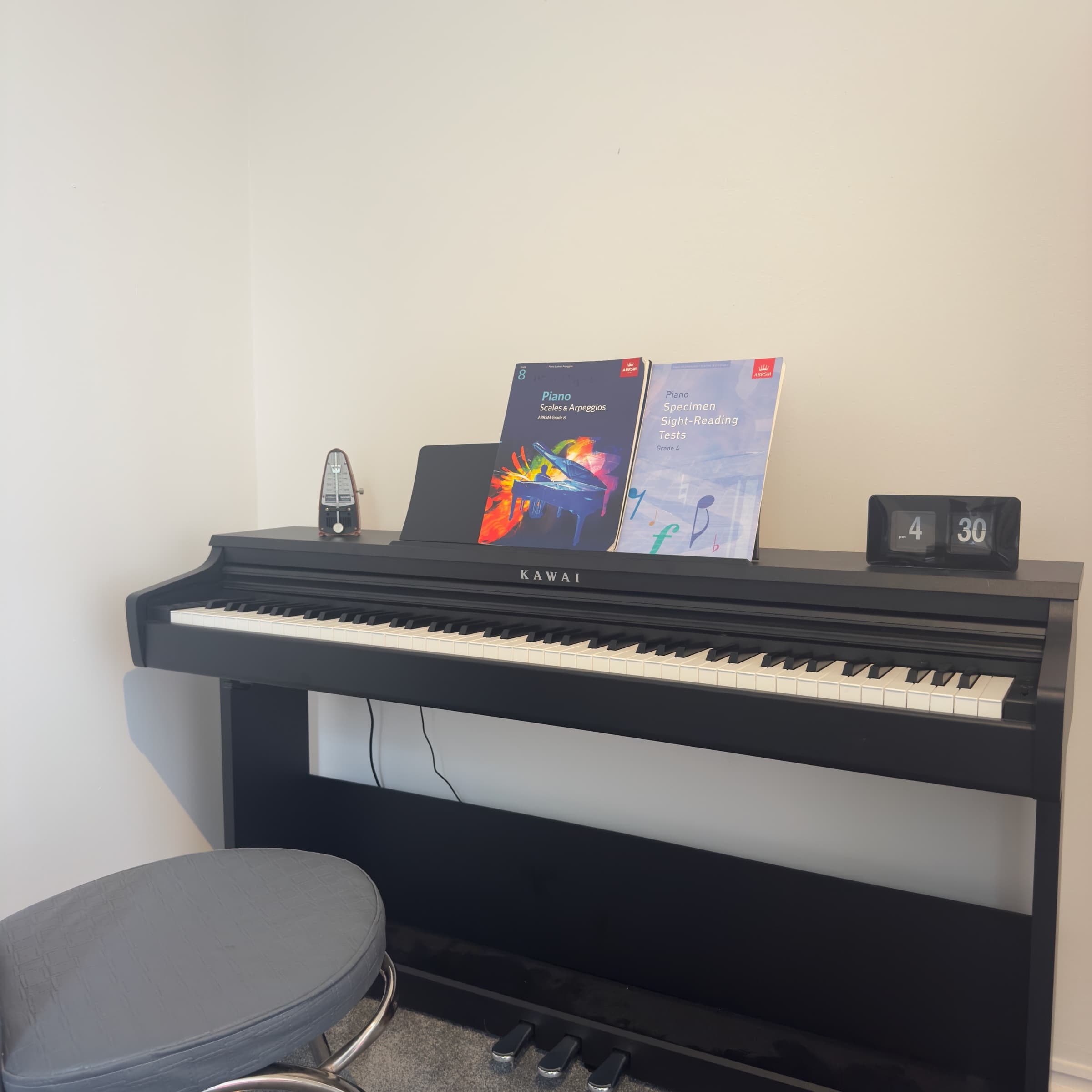 The Sandbanks Piano School studio — Kawai piano with ABRSM grade books and metronome